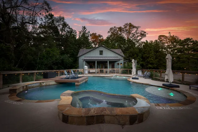 a view of a house with swimming pool and sitting area