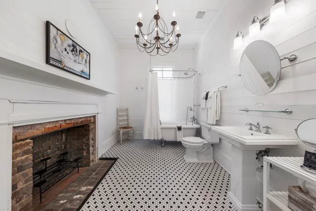 a bathroom with a sink a toilet and a mirror