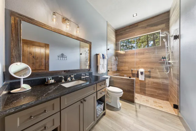 a bathroom with a double vanity sink a mirror and a shower