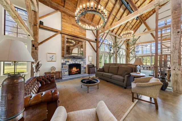 a living room with furniture a fireplace and a large window