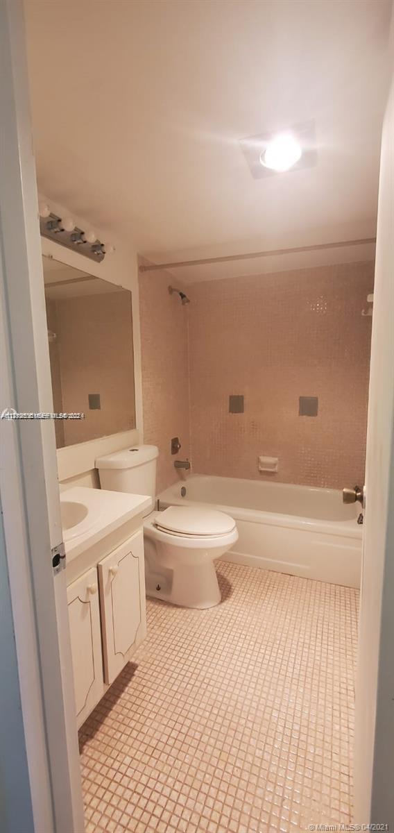 385 Fanshaw, Unit J Boca Raton, FL 33434 - Photo 2 of 7 a bathroom with a sink a toilet and shower