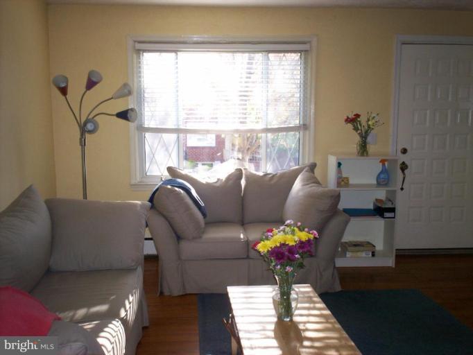 3822 Elkader Road Baltimore, MD 21218 - Photo 2 of 7 a living room with furniture and a window