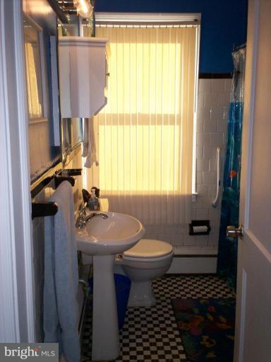 3822 Elkader Road Baltimore, MD 21218 - Photo 3 of 7 a bathroom with a sink toilet and shower