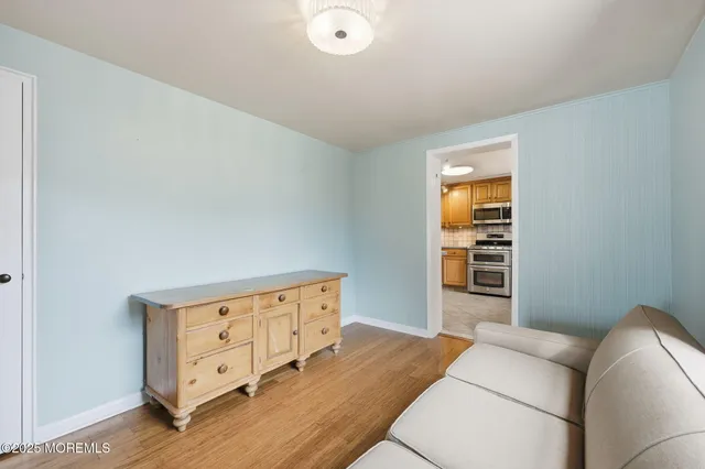 an empty room with windows and ceiling fan