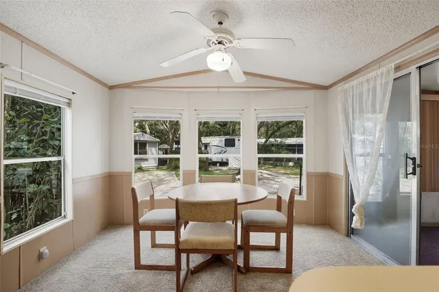 a view of a livingroom with furniture and a window