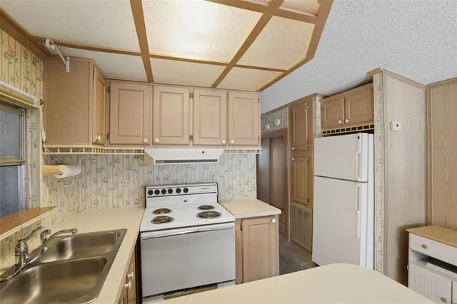 a kitchen with stainless steel appliances a refrigerator sink and cabinets