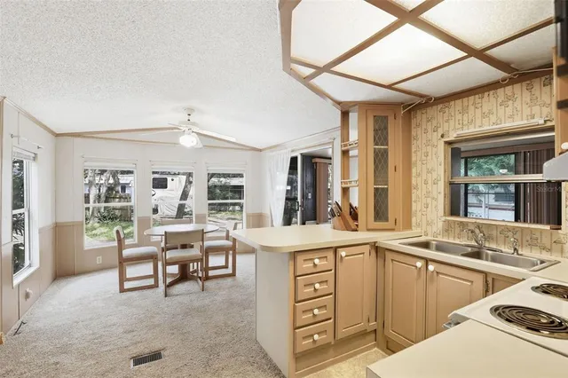 a view of a kitchen with furniture and windows
