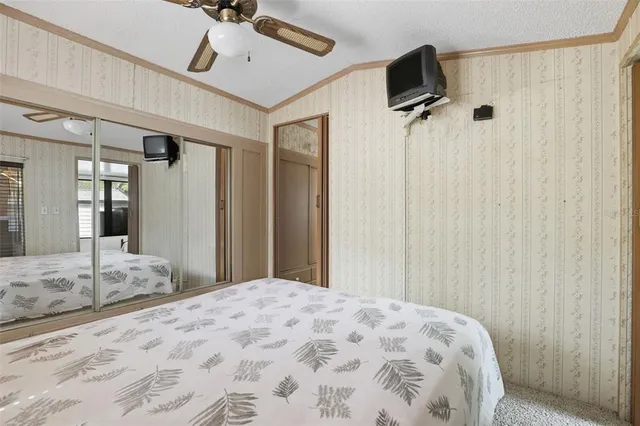 a bedroom with a bed and a flat tv screen