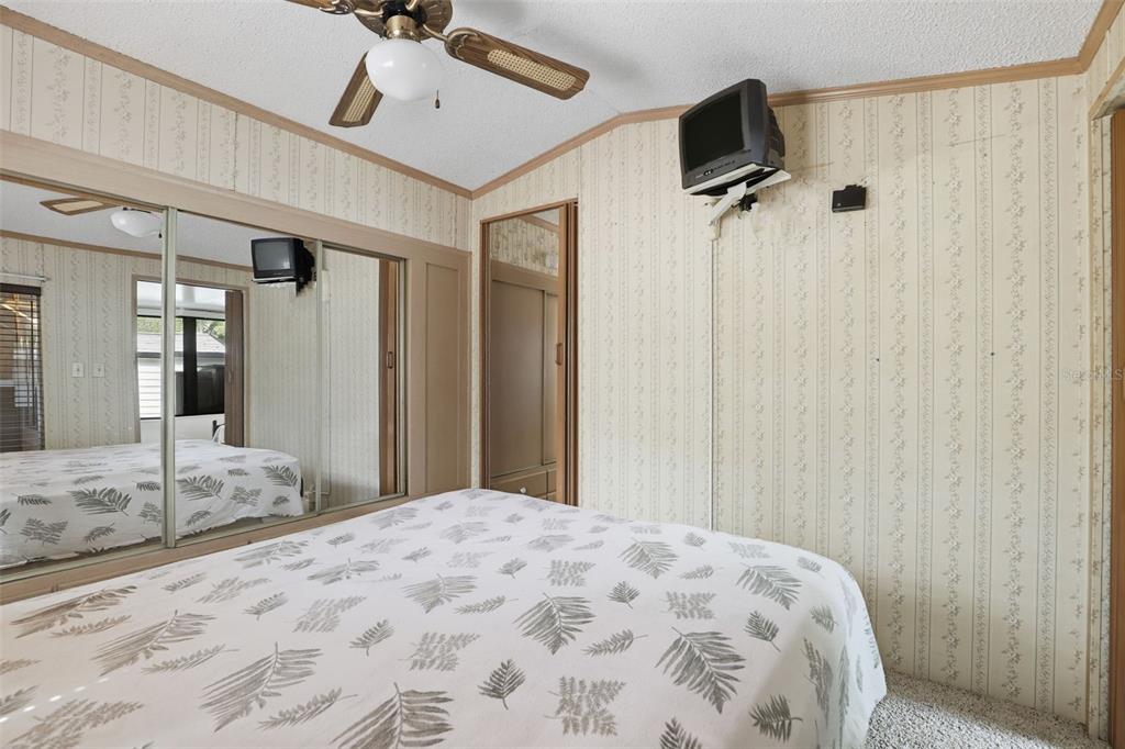 3000 Clarcona Road, Unit 362 Apopka, FL 32703 - Photo 19 of 32 a bedroom with a bed and a flat tv screen