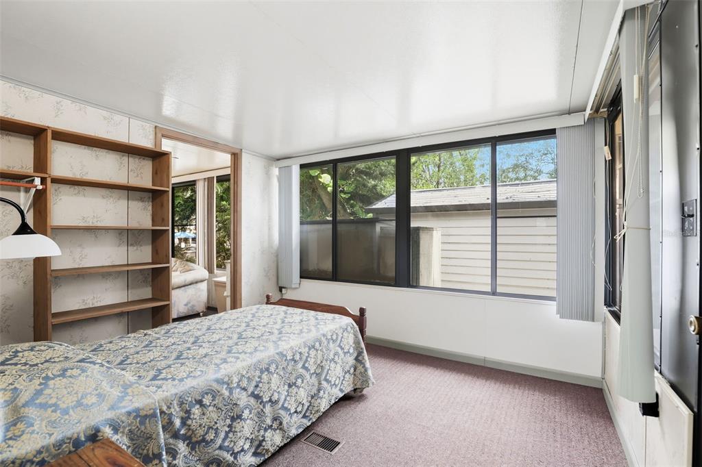 3000 Clarcona Road, Unit 362 Apopka, FL 32703 - Photo 22 of 32 a bedroom with a bed and a large window with the outer view