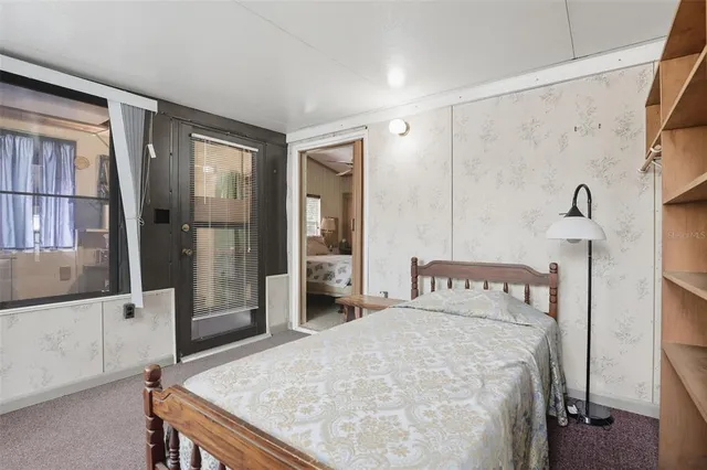 a bedroom with a bed and a dresser with mirror