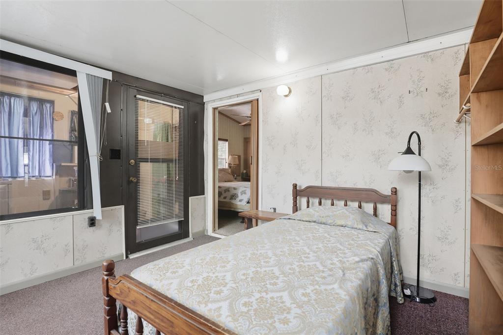 3000 Clarcona Road, Unit 362 Apopka, FL 32703 - Photo 23 of 32 a bedroom with a bed and a dresser with mirror