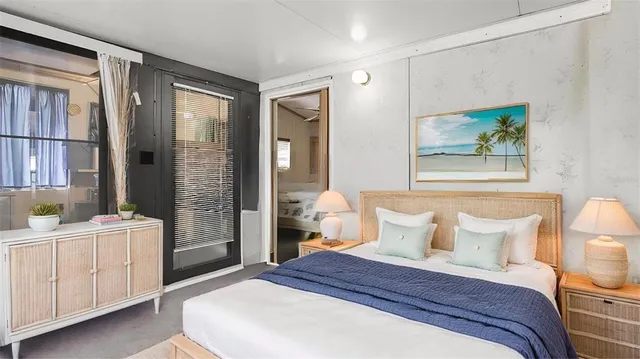 a bedroom with a bed and a chandelier