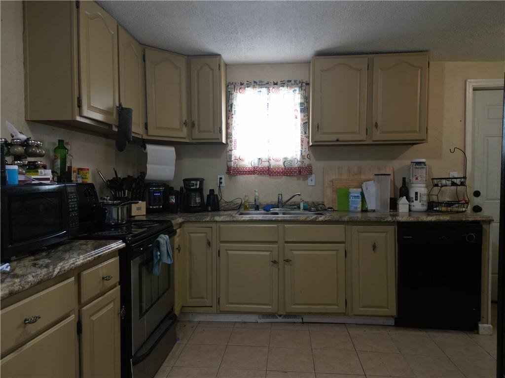 1119 Layton Road Butler, PA 16001 - Photo 3 of 25 a kitchen with granite countertop cabinets stainless steel appliances a sink and window
