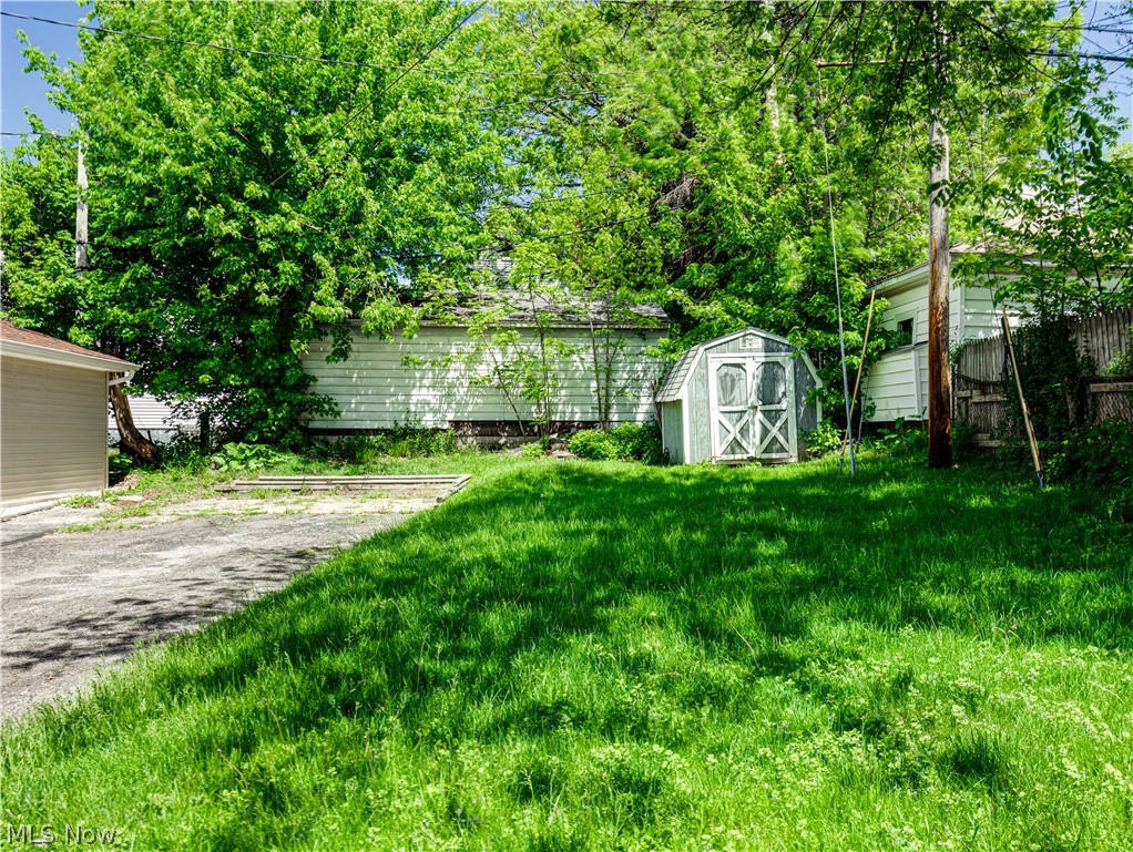377 East Wilbeth Road Akron, OH 44301 - Photo 23 of 25 View of yard featuring a storage unit