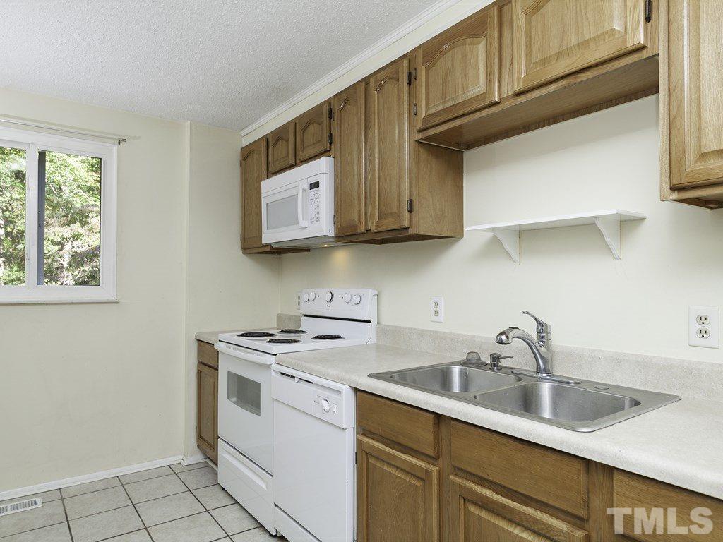 7261 Mine Shaft Road Raleigh, NC 27615 - Photo 8 of 25 a kitchen with stainless steel appliances granite countertop a sink and a stove