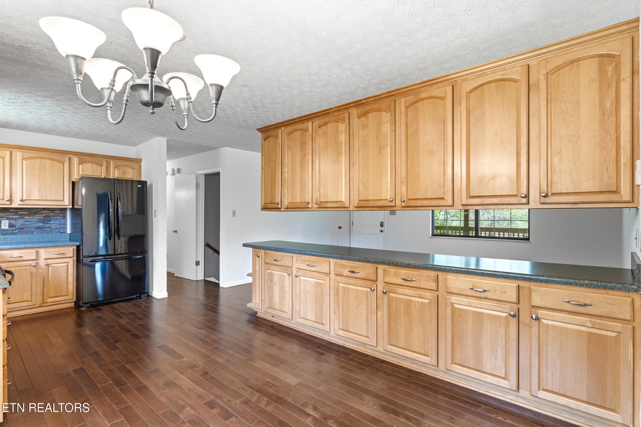 1835 Wilson Road Lenoir City, TN 37772 - Photo 12 of 57 a kitchen with stainless steel appliances granite countertop a refrigerator a sink dishwasher a oven with white cabinets and wooden floor