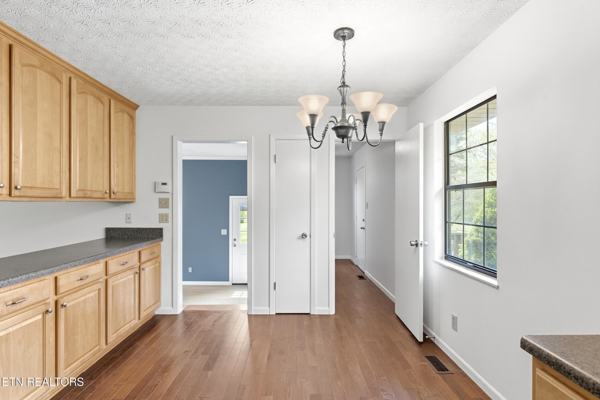 1835 Wilson Road Lenoir City, TN 37772 - Photo 13 of 57 a view of a big room with wooden floor chandeliers and kitchen view