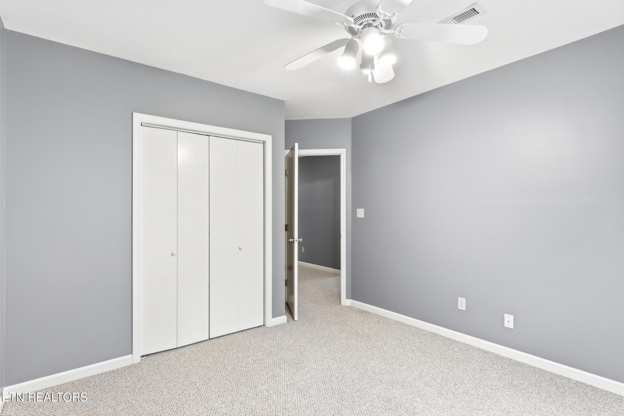 1835 Wilson Road Lenoir City, TN 37772 - Photo 31 of 57 an empty room with a ceiling fan and a fan