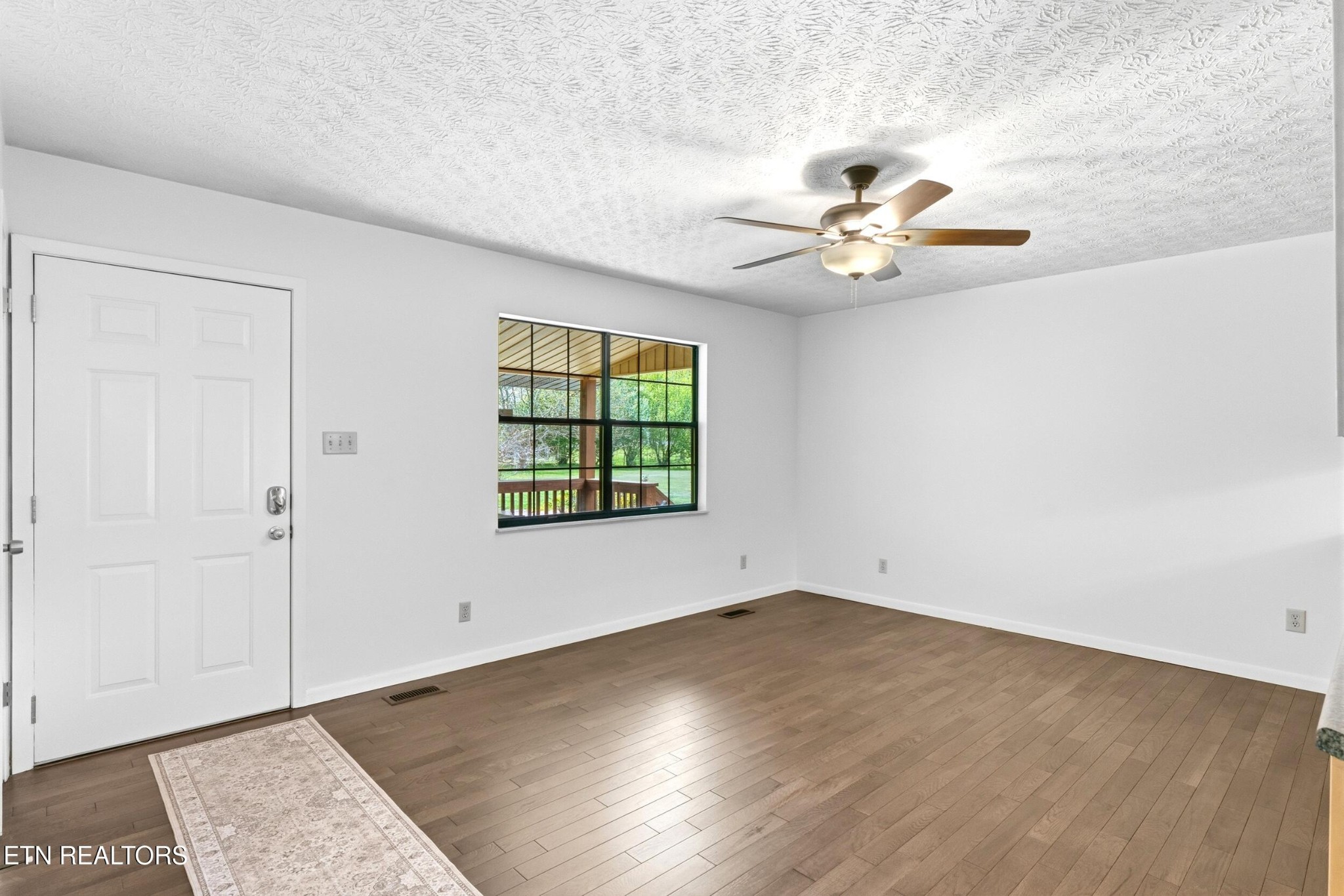 1835 Wilson Road Lenoir City, TN 37772 - Photo 8 of 57 wooden floor in an empty room with a window