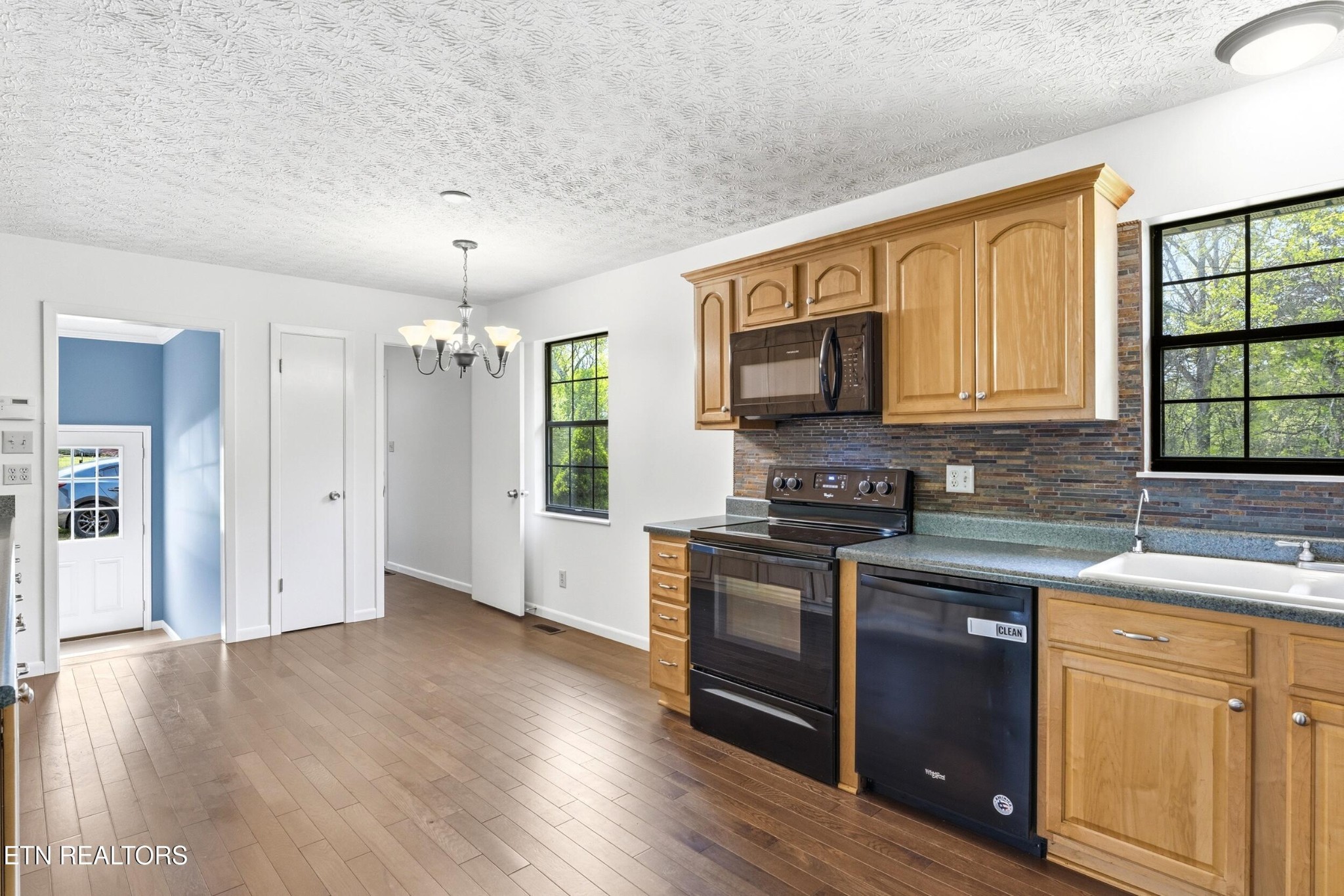 1835 Wilson Road Lenoir City, TN 37772 - Photo 9 of 57 a kitchen with granite countertop wooden floors and stainless steel appliances
