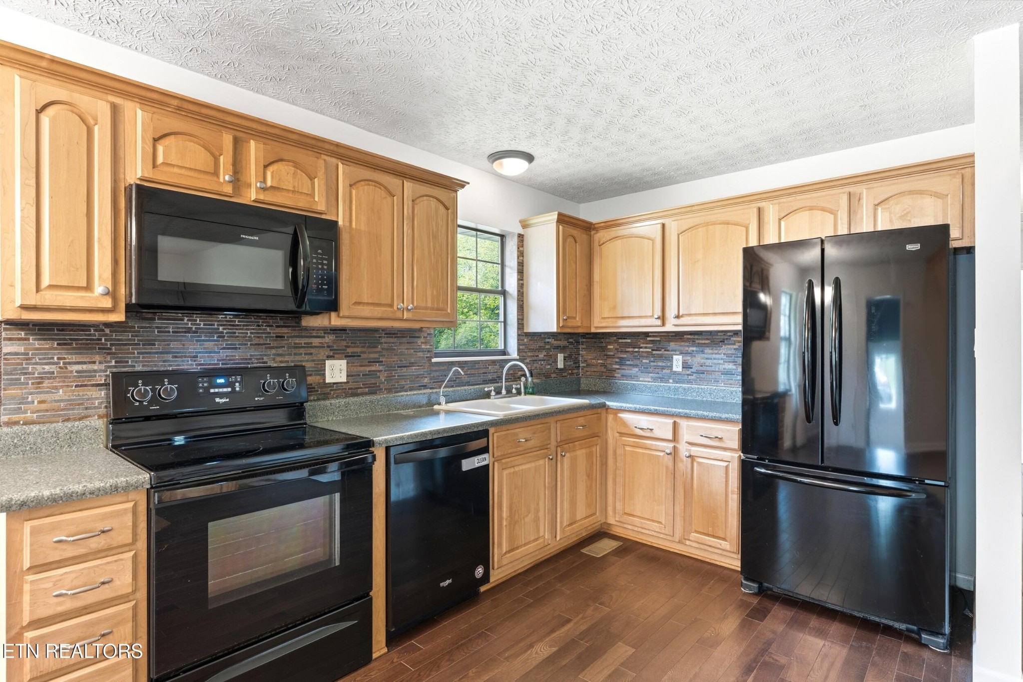 1835 Wilson Road Lenoir City, TN 37772 - Photo 10 of 57 a kitchen with stainless steel appliances granite countertop a stove microwave refrigerator and sink