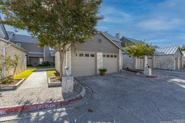 a view of a house with backyard and a tree