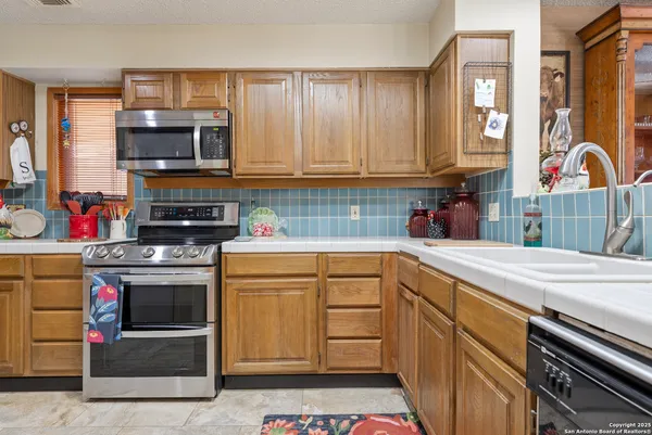 a kitchen with stainless steel appliances granite countertop a stove and a sink