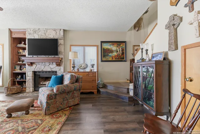 a living room with furniture a flat screen tv and a fireplace