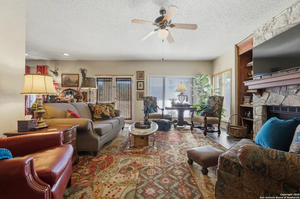 a living room with furniture a large window and a flat screen tv