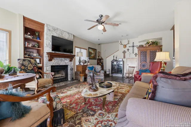 a living room with furniture a flat screen tv and a fireplace