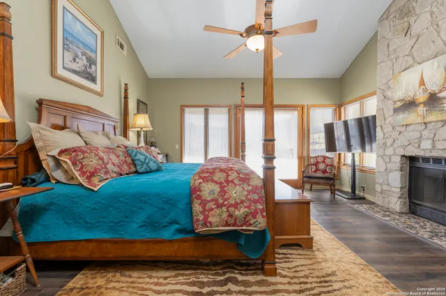 a bedroom with a large bed and a fireplace