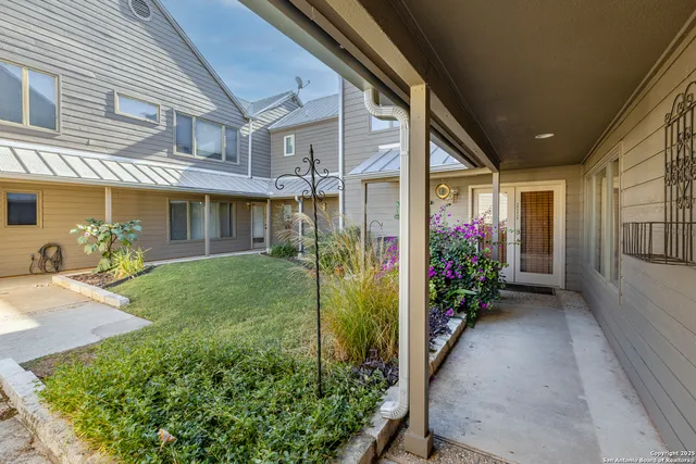 a view of a house with potted plants