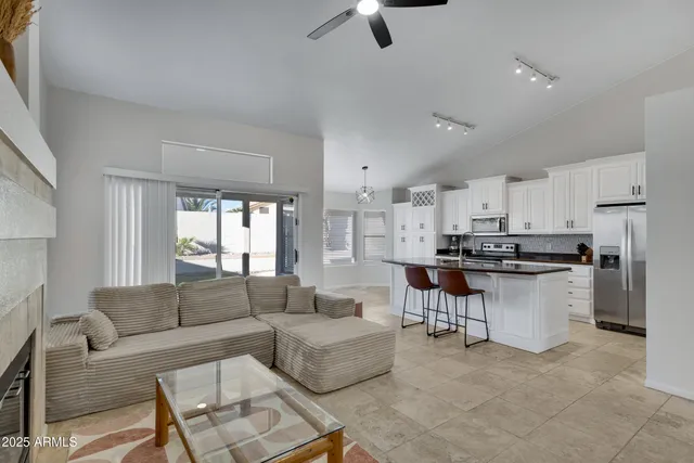 a living room with furniture and kitchen view