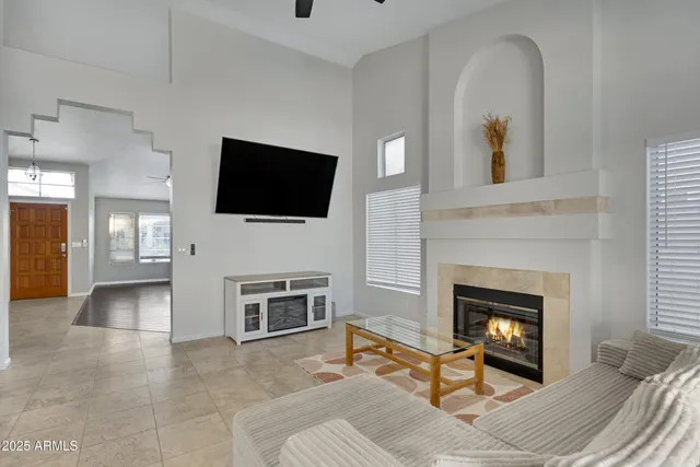 a living room with furniture a fireplace and a flat screen tv