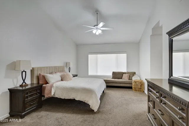 a bedroom with bed and window