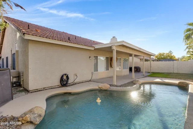 a backyard with table and chairs