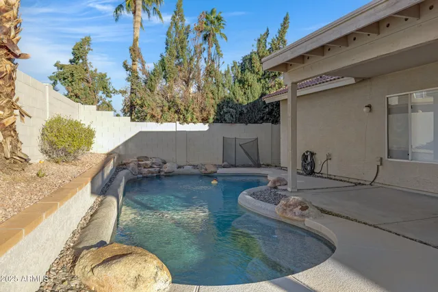 a view of a swimming pool with a yard