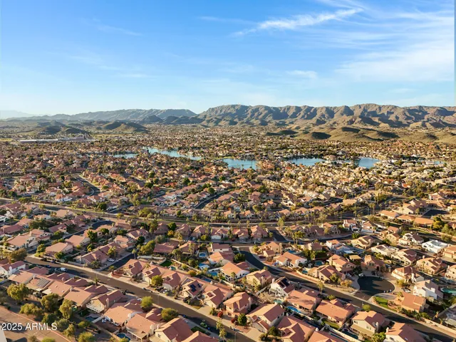 an aerial view of residential building and trees around