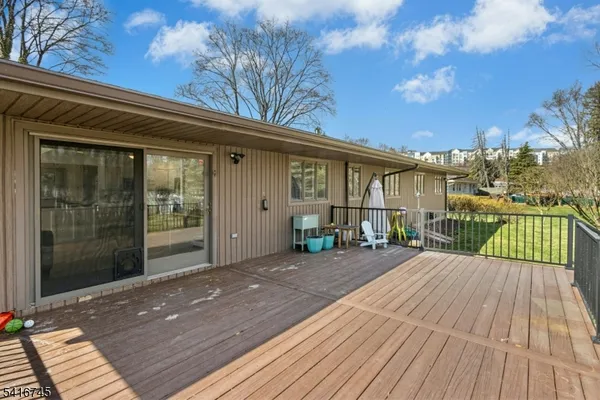 a view of a wooden deck with a yard