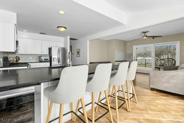 a kitchen with a table chairs refrigerator and cabinets