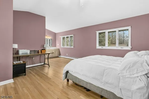 a spacious bedroom with a bed and a cabinets