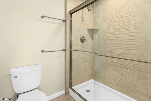 a bathroom with a toilet and shower