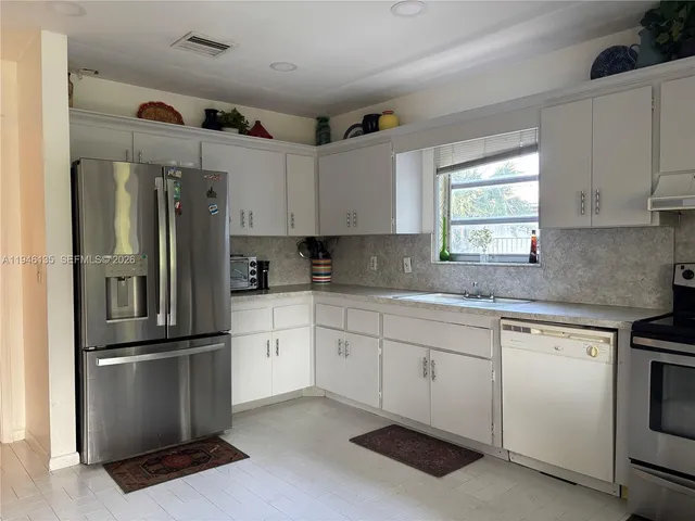 a bedroom with a bed window and dresser
