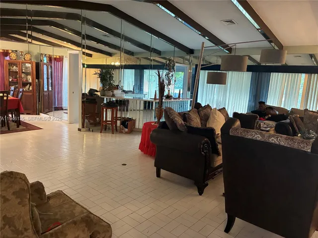 a bedroom with furniture and a book shelf