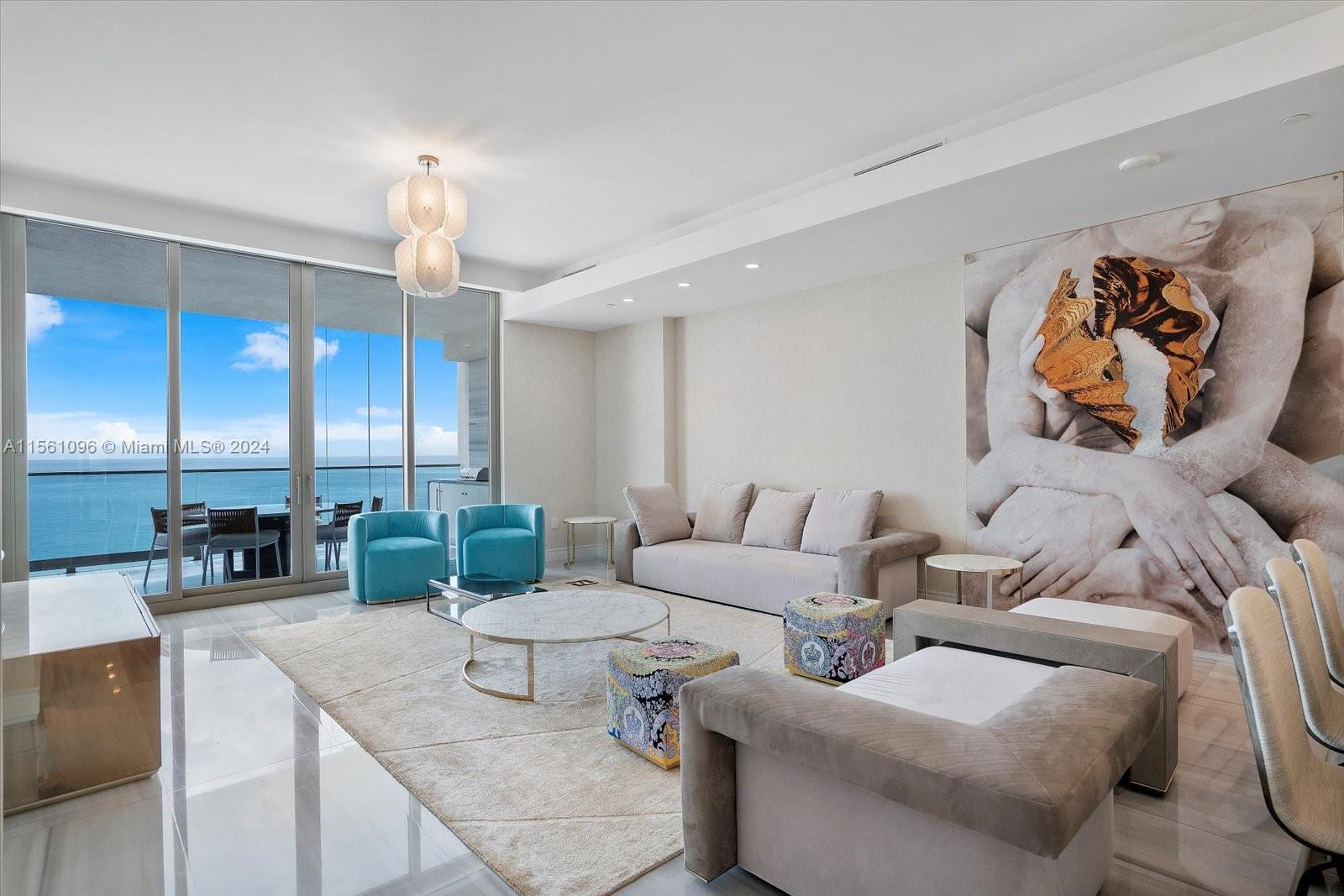 17901 Collins Avenue, Unit 902 Sunny Isles Beach, FL 33160 - Photo 1 of 47 a living room with furniture and a chandelier