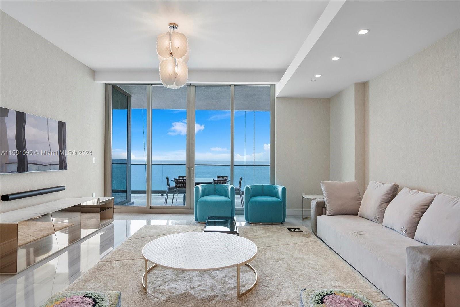 17901 Collins Avenue, Unit 902 Sunny Isles Beach, FL 33160 - Photo 11 of 47 a living room with furniture a chandelier and a chandelier