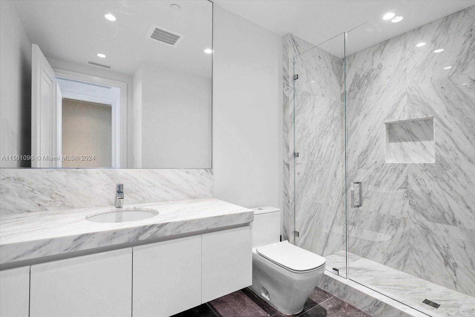 17901 Collins Avenue, Unit 902 Sunny Isles Beach, FL 33160 - Photo 36 of 47 a bathroom with a granite countertop sink toilet and shower