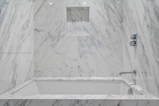 a bedroom with a large bed and a large window