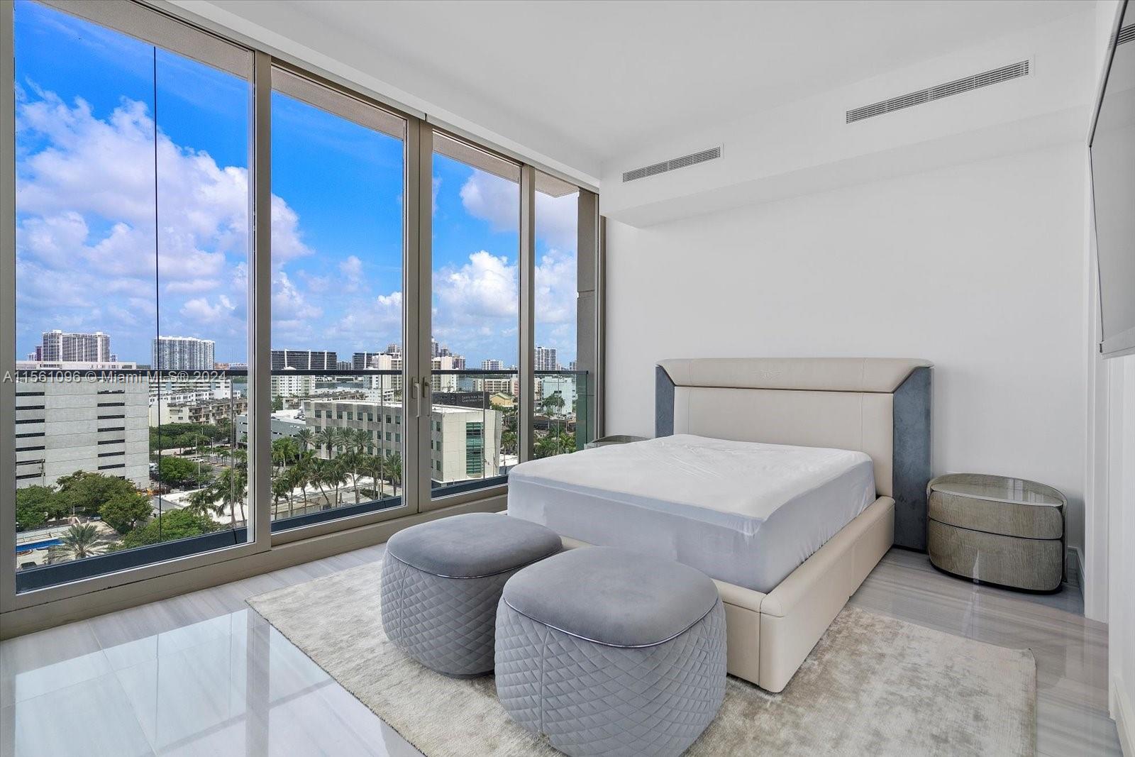 17901 Collins Avenue, Unit 902 Sunny Isles Beach, FL 33160 - Photo 40 of 47 a bedroom with a large bed and a large window